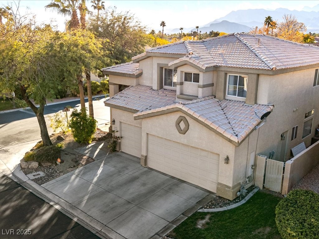 5505 Big Sky Lane Las Vegas, NV 89149 - Photo 16 of 42 View of front facade featuring stucco siding, a tiled roof, an attached garage, and driveway