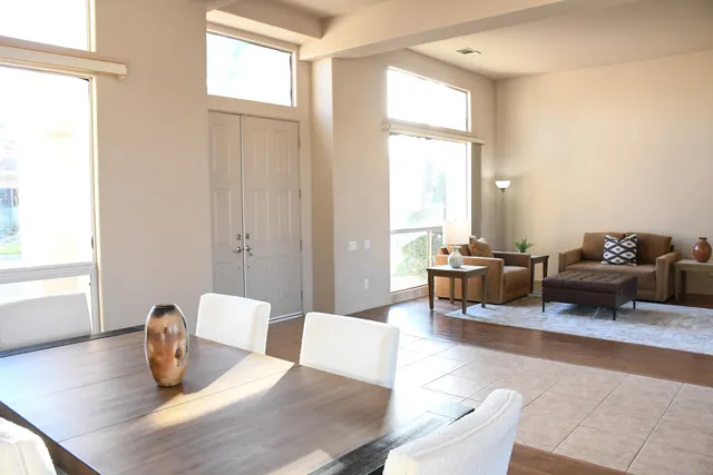 a view of a workspace with furniture and a window