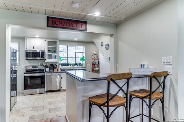a kitchen with stainless steel appliances granite countertop a stove and a sink