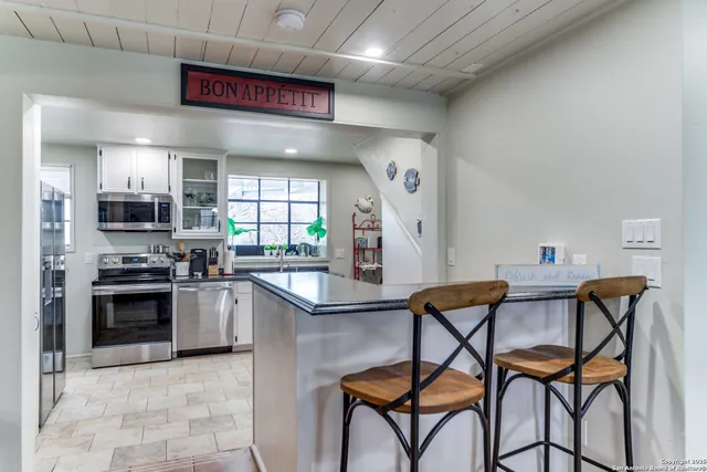 a kitchen with stainless steel appliances granite countertop a stove and a sink