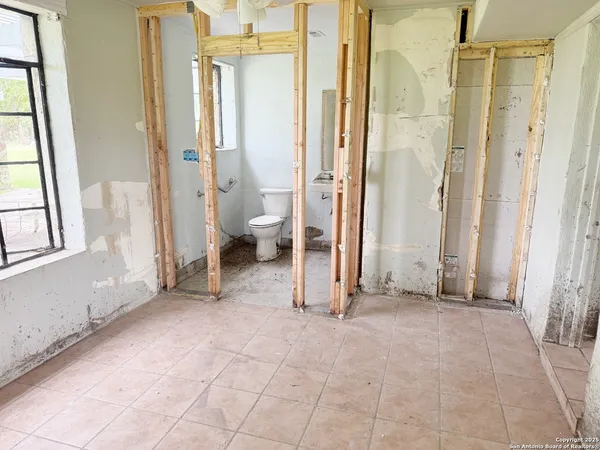 a view of a a dining room with furniture window and wooden floor
