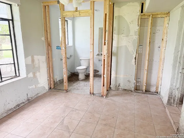 a view of a a dining room with furniture window and wooden floor