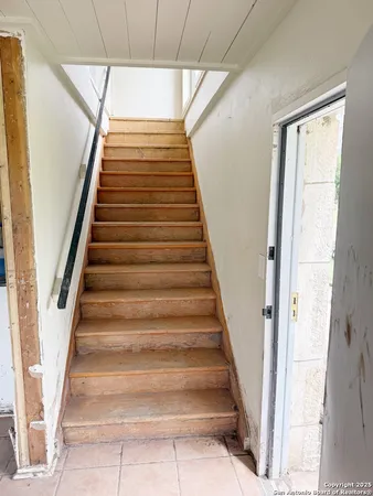a bedroom with a bed a window and dresser
