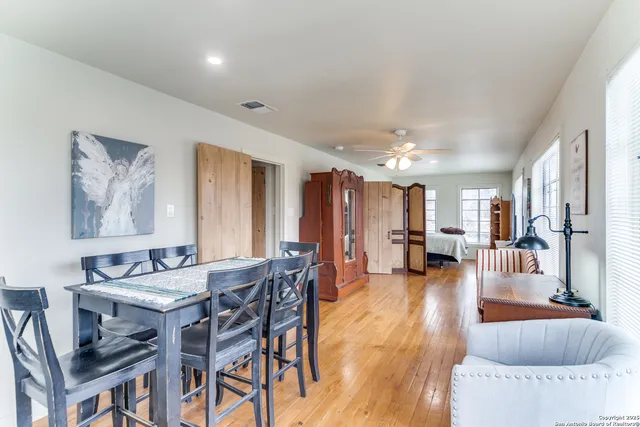 a view of a livingroom with furniture and a table chairs