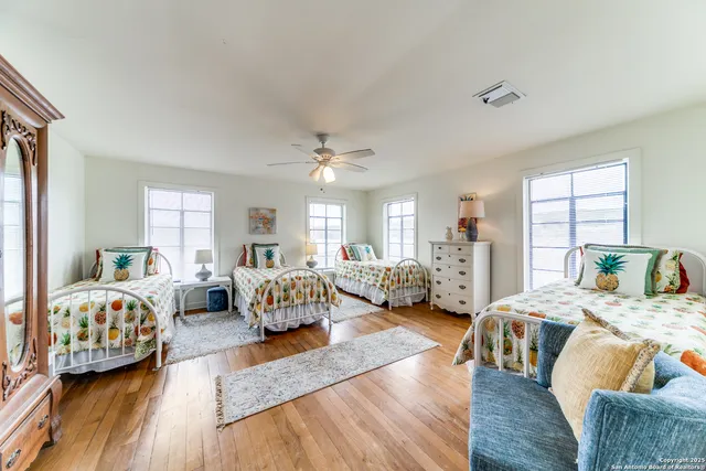 a bedroom with furniture and a large window