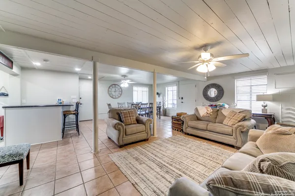 a living room with furniture and a chandelier