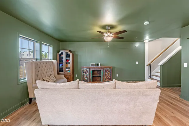 a living room with furniture and a chandelier