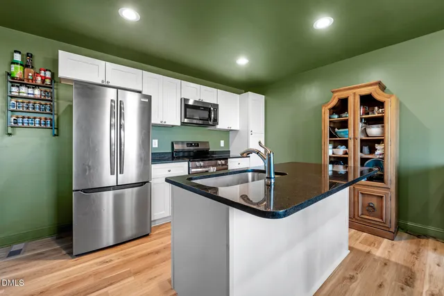 a kitchen with a table and chairs