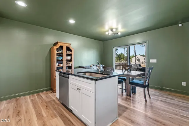 a kitchen with stainless steel appliances granite countertop a refrigerator a stove top oven a sink and dishwasher