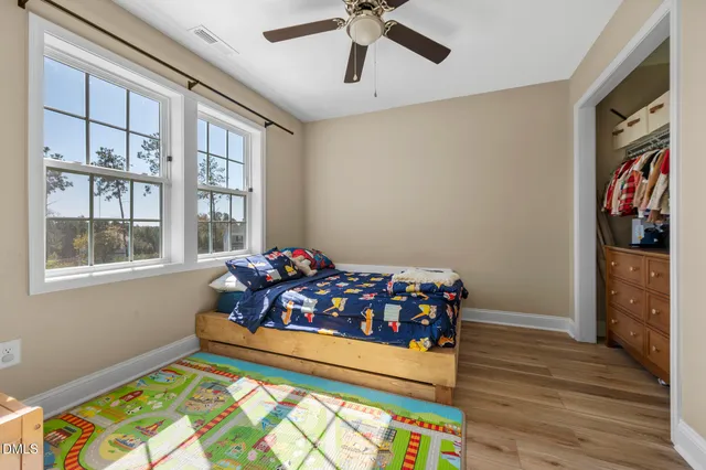 a view of a room with wooden floor and closet