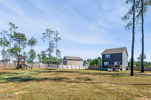 a swimming pool with yard and outdoor seating