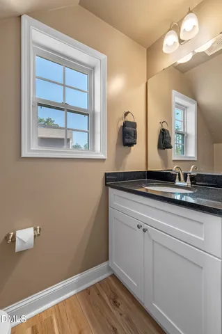 a view of a hallway with wooden floor and entryway
