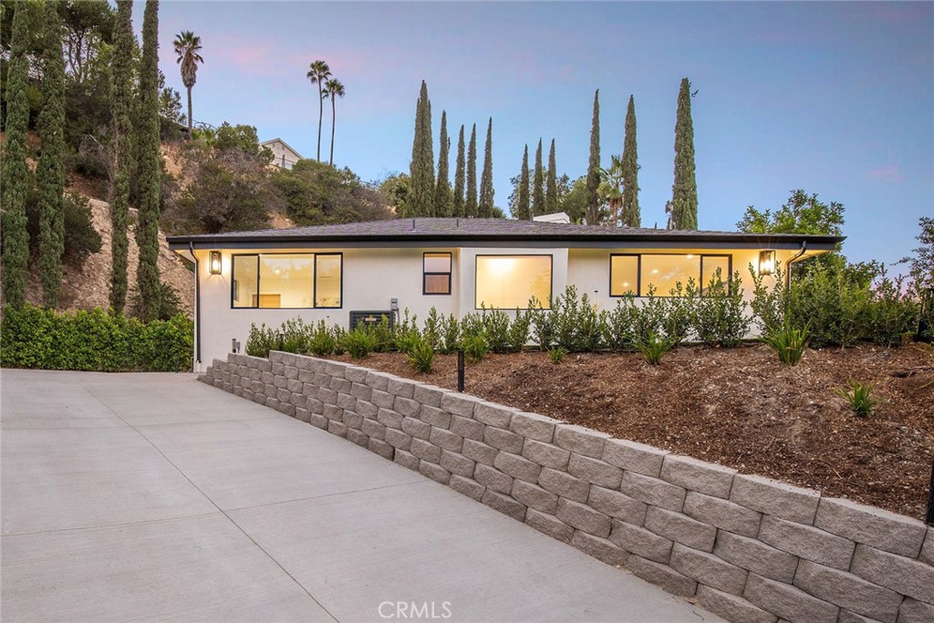15625 High Knoll Road Encino, CA 91436 - Photo 1 of 1 a view of a house with a yard and potted plants