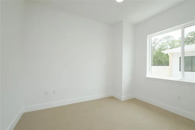 a view of a small space with wooden floor and a window