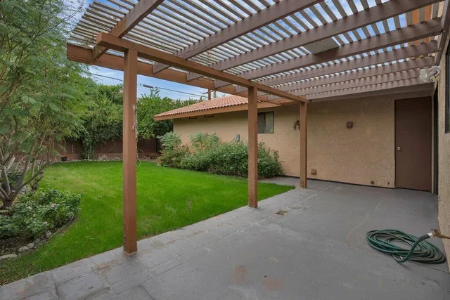 a view of a house with backyard and porch