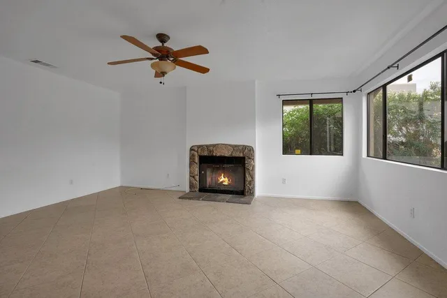 a living room with a ceiling fan and a window