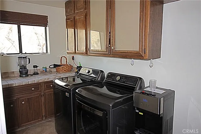 a kitchen with granite countertop a sink stove and cabinets