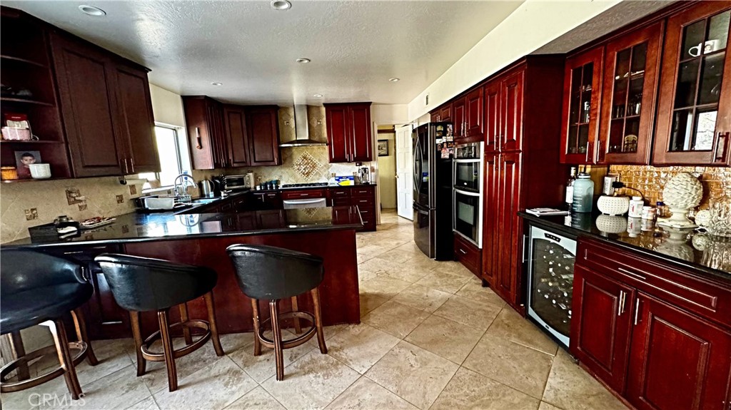 132 Rio Del Loma Kernville, CA 93238 - Photo 8 of 33 a kitchen with stainless steel appliances granite countertop sink stove top oven and cabinets