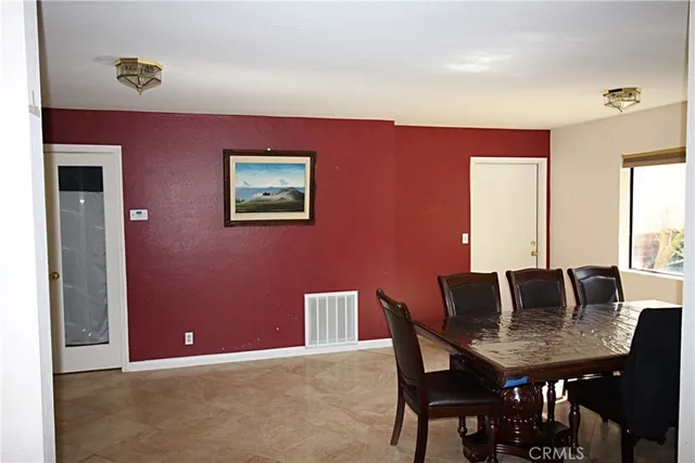 a view of a dining room with furniture and window