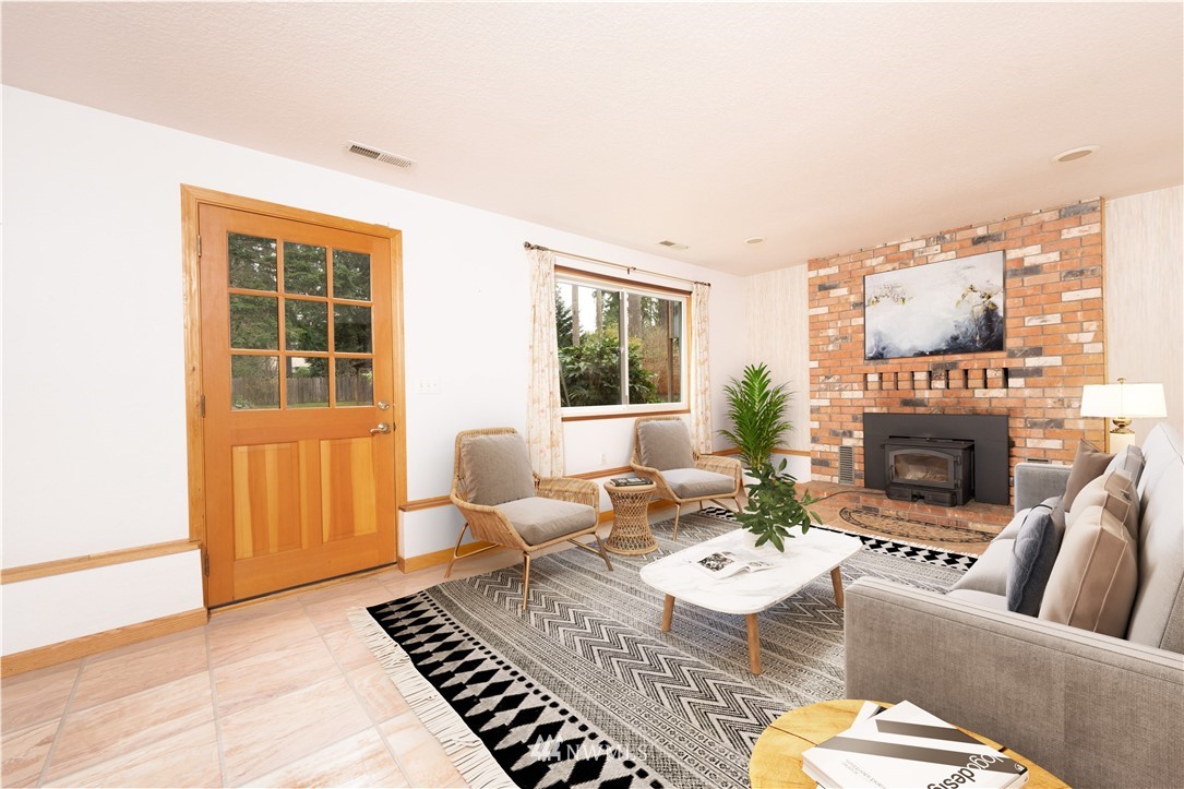 105 West Winesap Road Bothell, WA 98012 - Photo 12 of 40 a living room with furniture and a fireplace