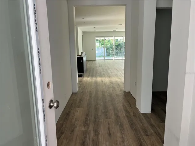 a view of a hallway with wooden floor