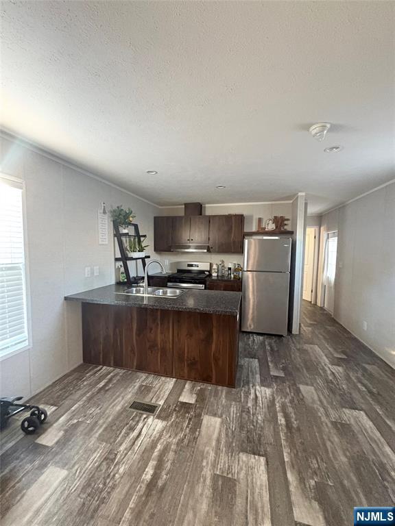 a kitchen with a refrigerator and a counter top space