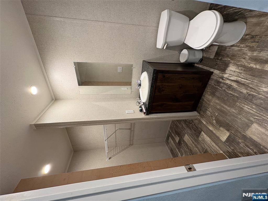 131 Elm Street Lodi, NJ 07644 - Photo 12 of 18 a bathroom with a sink and a toilet
