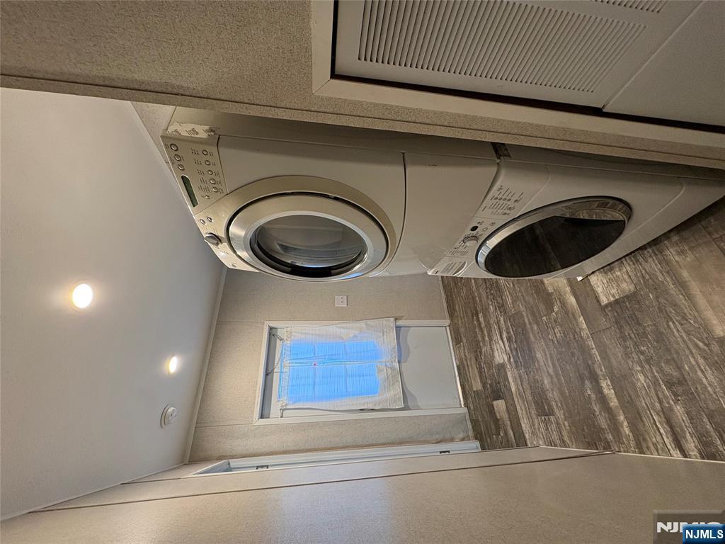 131 Elm Street Lodi, NJ 07644 - Photo 15 of 18 a view of a storage and utility room with washer and dryer