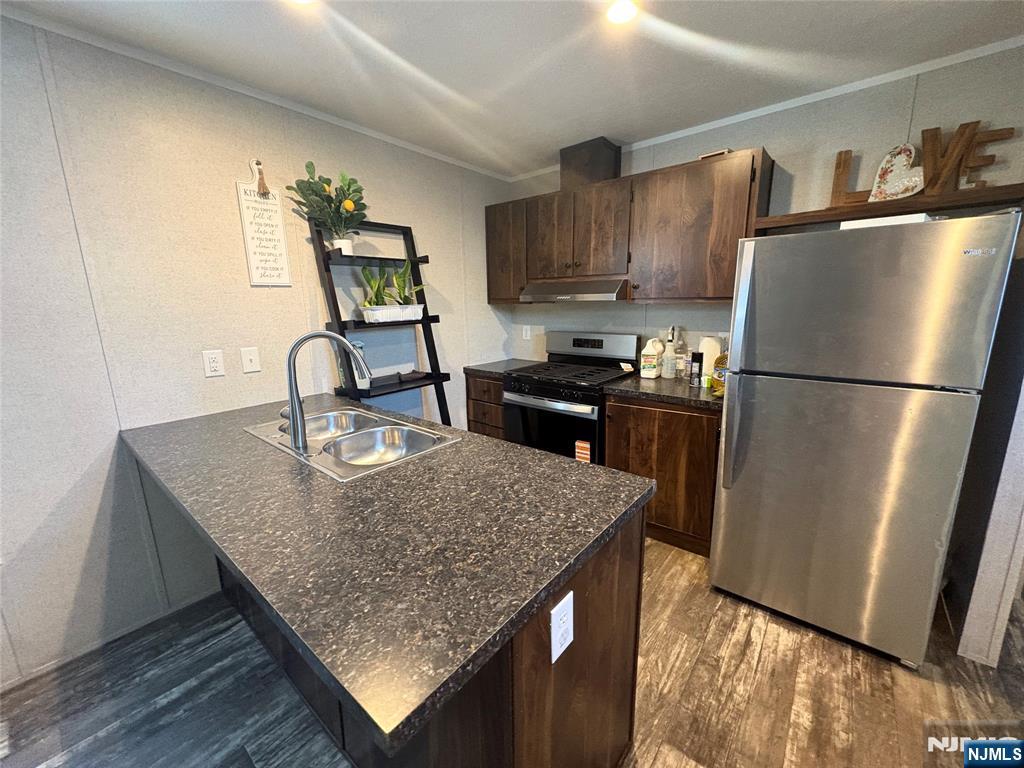 131 Elm Street Lodi, NJ 07644 - Photo 17 of 20 a kitchen with sink refrigerator and microwave