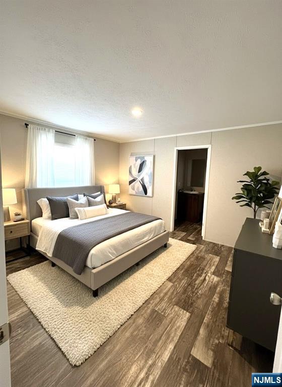 131 Elm Street Lodi, NJ 07644 - Photo 18 of 20 a bedroom with a large bed and a potted plant