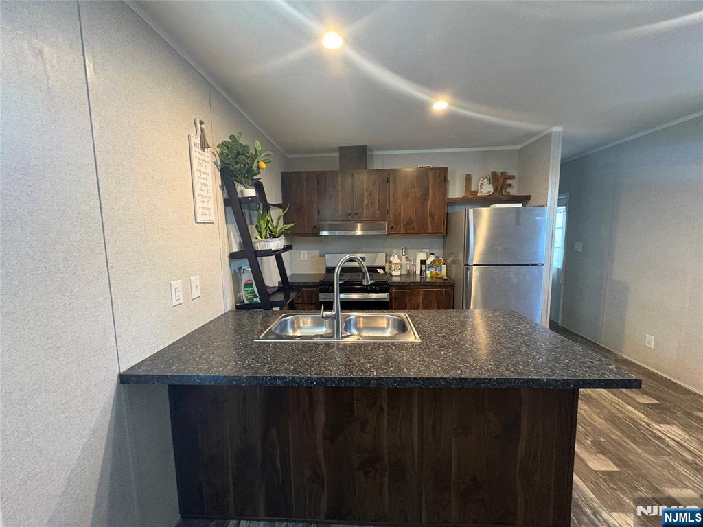 131 Elm Street Lodi, NJ 07644 - Photo 2 of 18 a kitchen with a table chairs and refrigerator