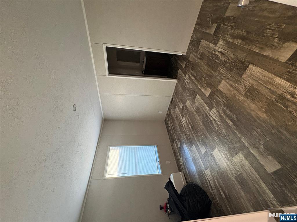 131 Elm Street Lodi, NJ 07644 - Photo 7 of 20 a view of empty room and wooden floor