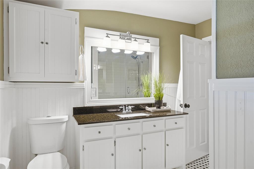 9121 6th Street Frisco, TX 75033 - Photo 15 of 27 a bathroom with a sink and a mirror