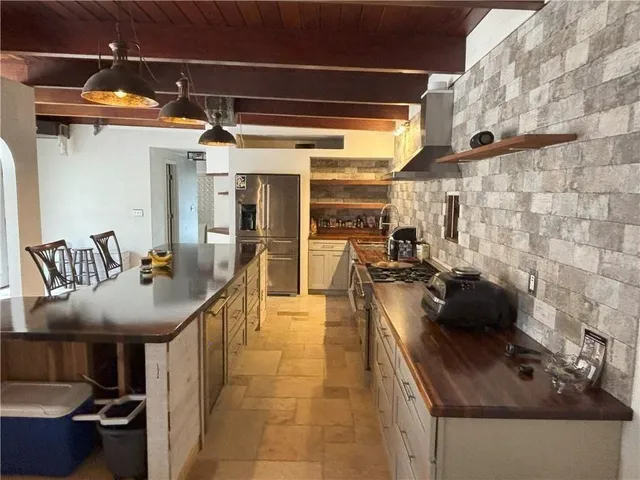 a kitchen with a sink a counter and chairs