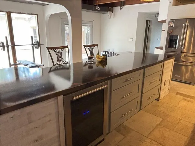 a kitchen with stainless steel appliances a sink a stove and a refrigerator