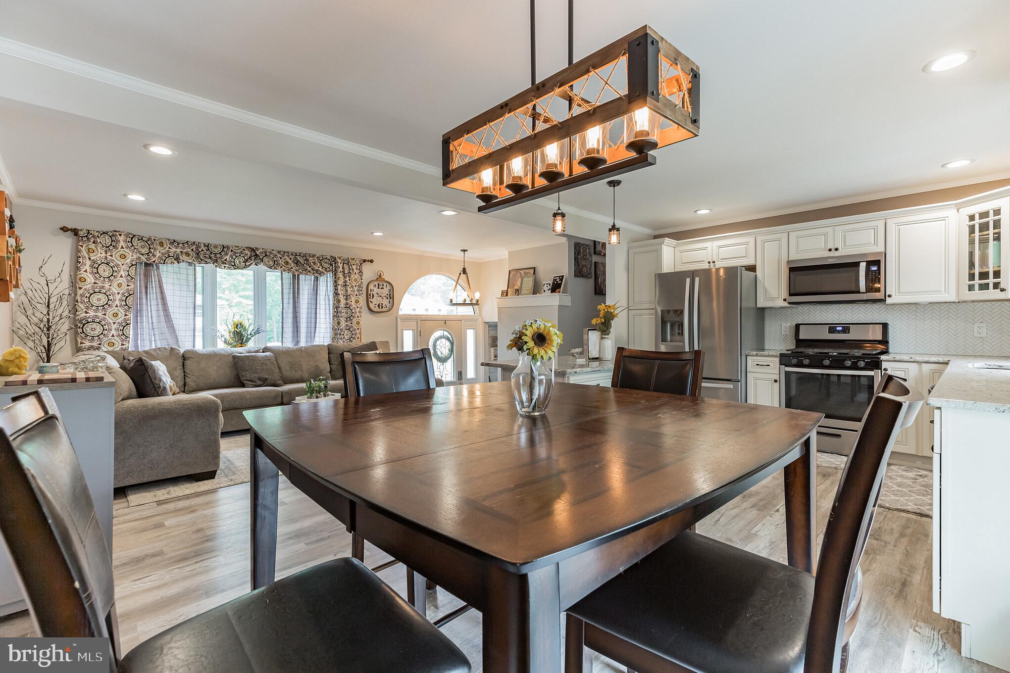 255 Winding Way Road Stratford, NJ 08084 - Photo 12 of 31 a view of a dining room with furniture and a chandelier