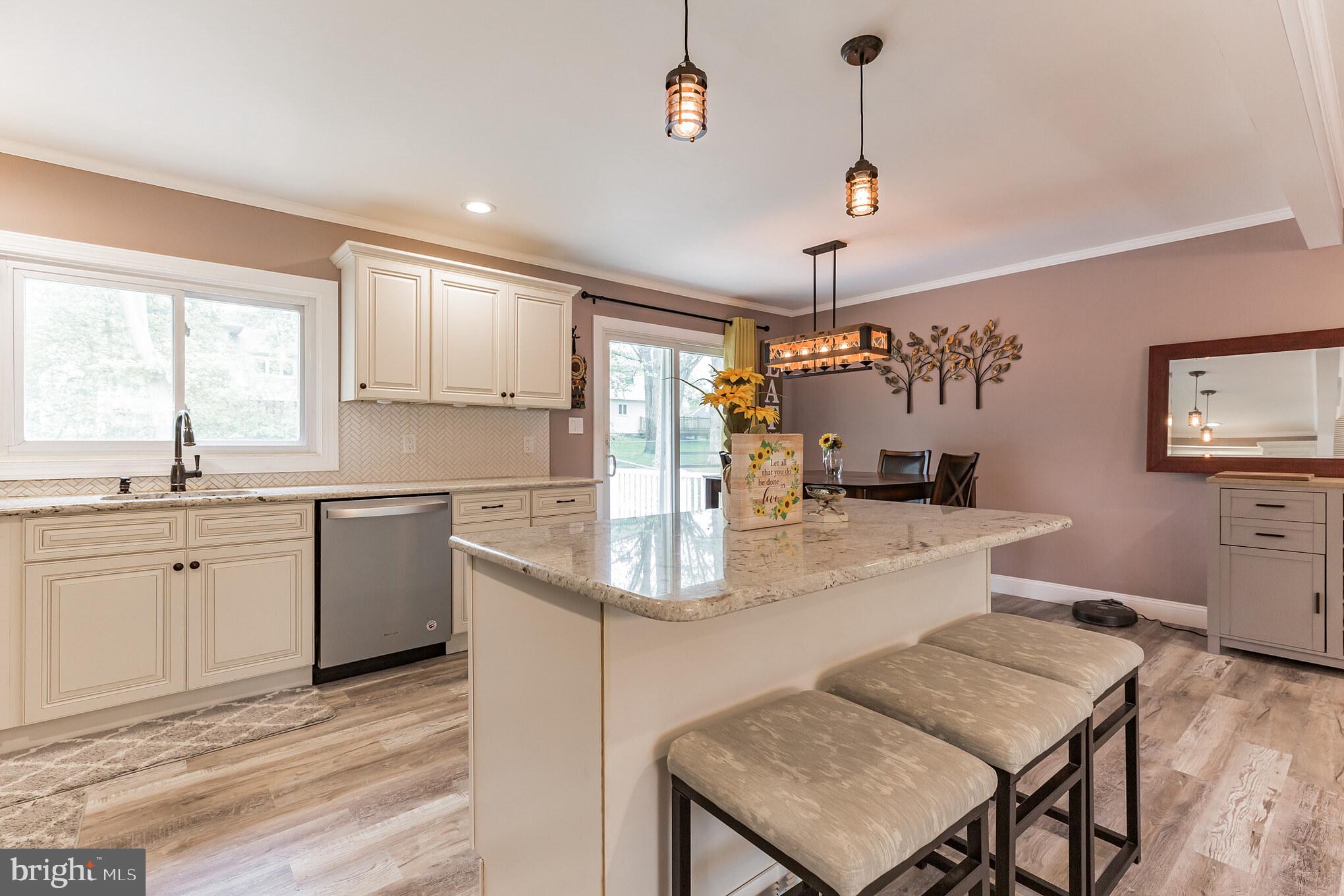 255 Winding Way Road Stratford, NJ 08084 - Photo 13 of 31 a kitchen with granite countertop a sink window and refrigerator