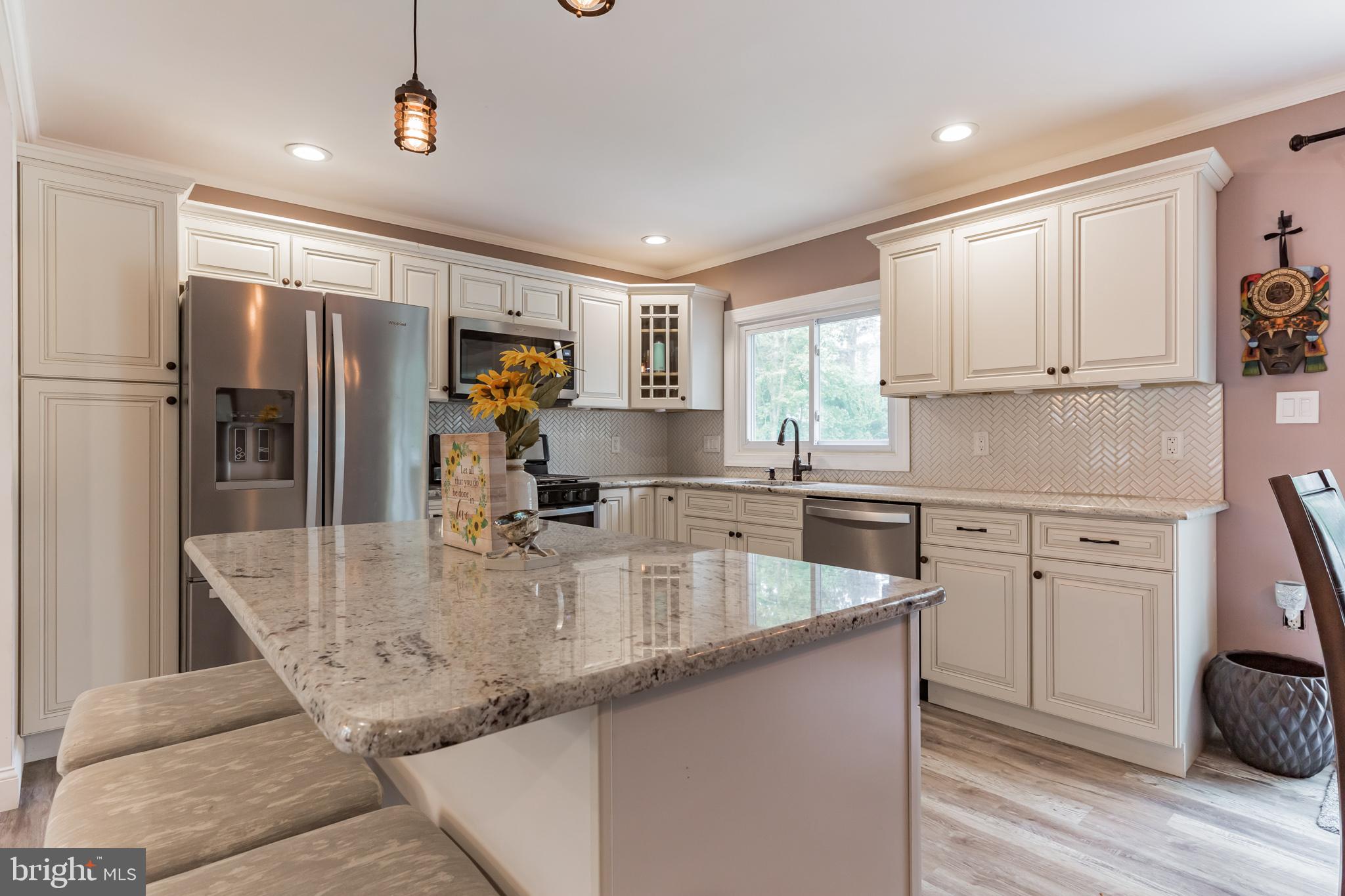 255 Winding Way Road Stratford, NJ 08084 - Photo 15 of 31 a kitchen with stainless steel appliances granite countertop a sink refrigerator and cabinets