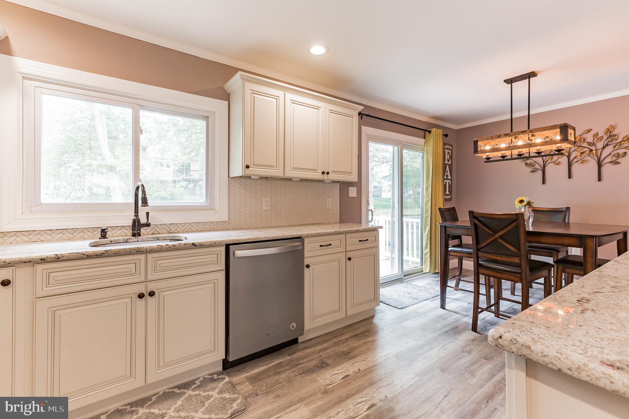 255 Winding Way Road Stratford, NJ 08084 - Photo 16 of 31 a kitchen with sink cabinets and wooden floor