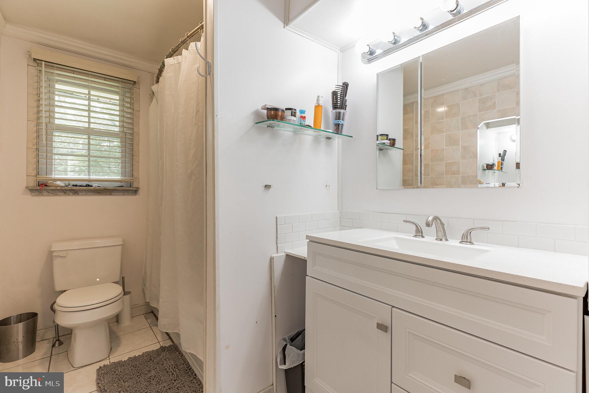 255 Winding Way Road Stratford, NJ 08084 - Photo 18 of 31 a bathroom with a toilet sink and mirror