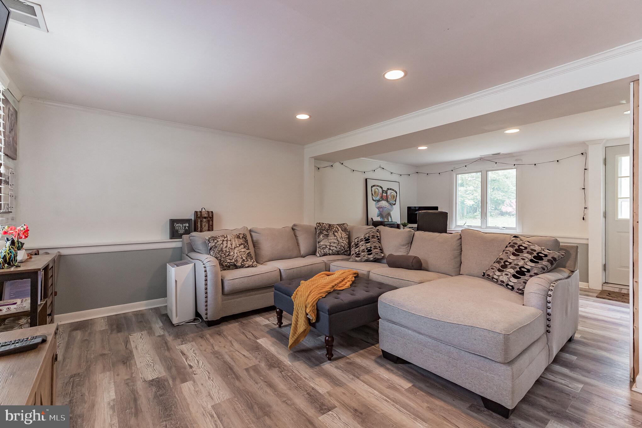 255 Winding Way Road Stratford, NJ 08084 - Photo 23 of 31 a living room with furniture and a wooden floor