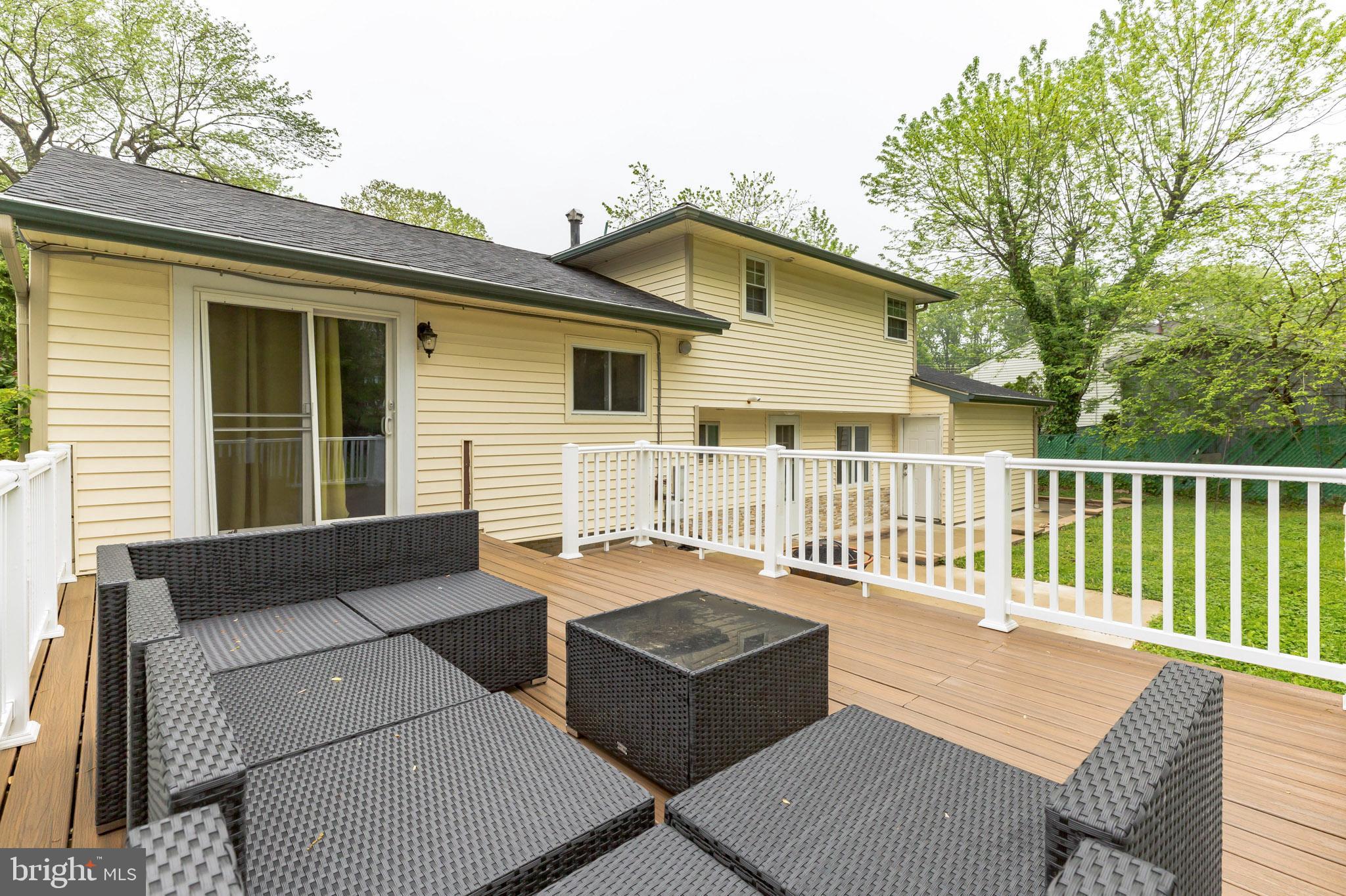 255 Winding Way Road Stratford, NJ 08084 - Photo 28 of 31 a view of a deck with couches floor to ceiling window with wooden fence