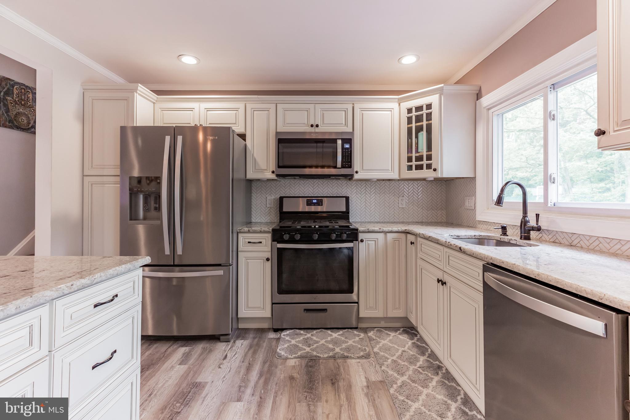 255 Winding Way Road Stratford, NJ 08084 - Photo 10 of 31 a kitchen with a refrigerator stove and sink