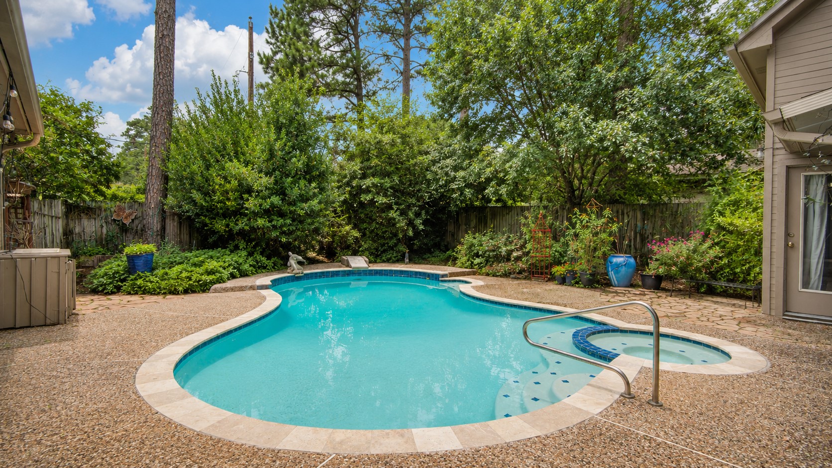 8412 Hidden Trail Lane Spring, TX 77379 - Photo 1 of 38 The private backyard retreat features a sparkling pool surrounded by mature trees, creating a peaceful setting for relaxing or entertaining.