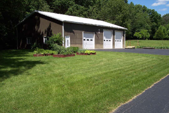 3302 South Butternut Road Oregon, IL 61061 - Photo 5 of 5 a front view of a house with a garden