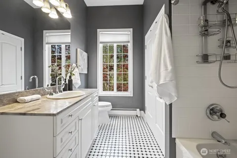 a bathroom with a granite countertop sink and a mirror