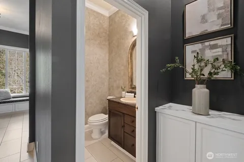 a bathroom with a granite countertop sink a toilet and a mirror