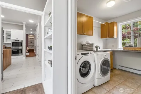 a utility room with sink dryer and washer