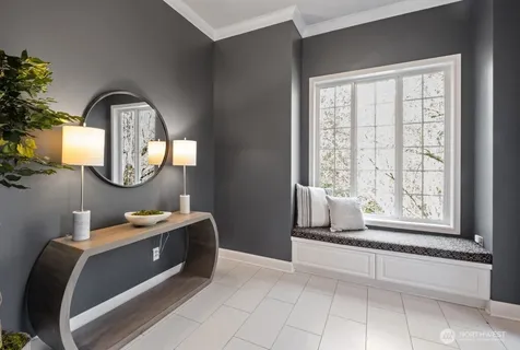 a room with a bed a mirror and a window