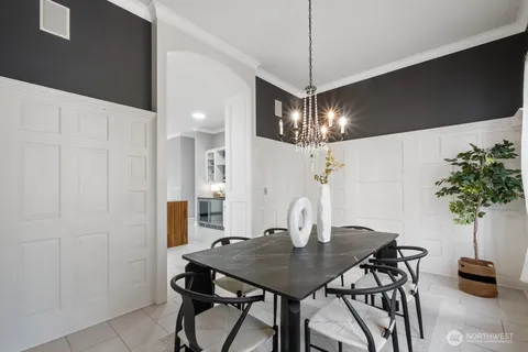 a view of a dining room with furniture and chandelier